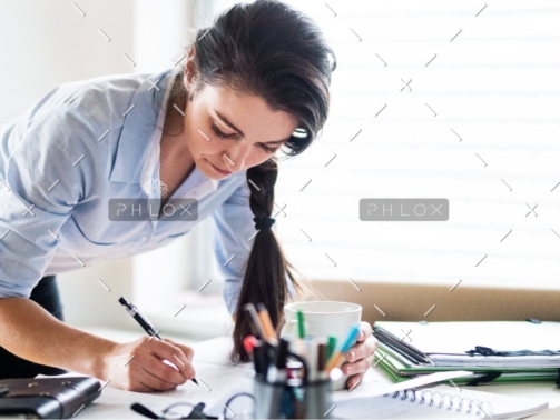 demo-attachment-172-a-portrait-of-a-woman-working-at-home-PW6FL9X